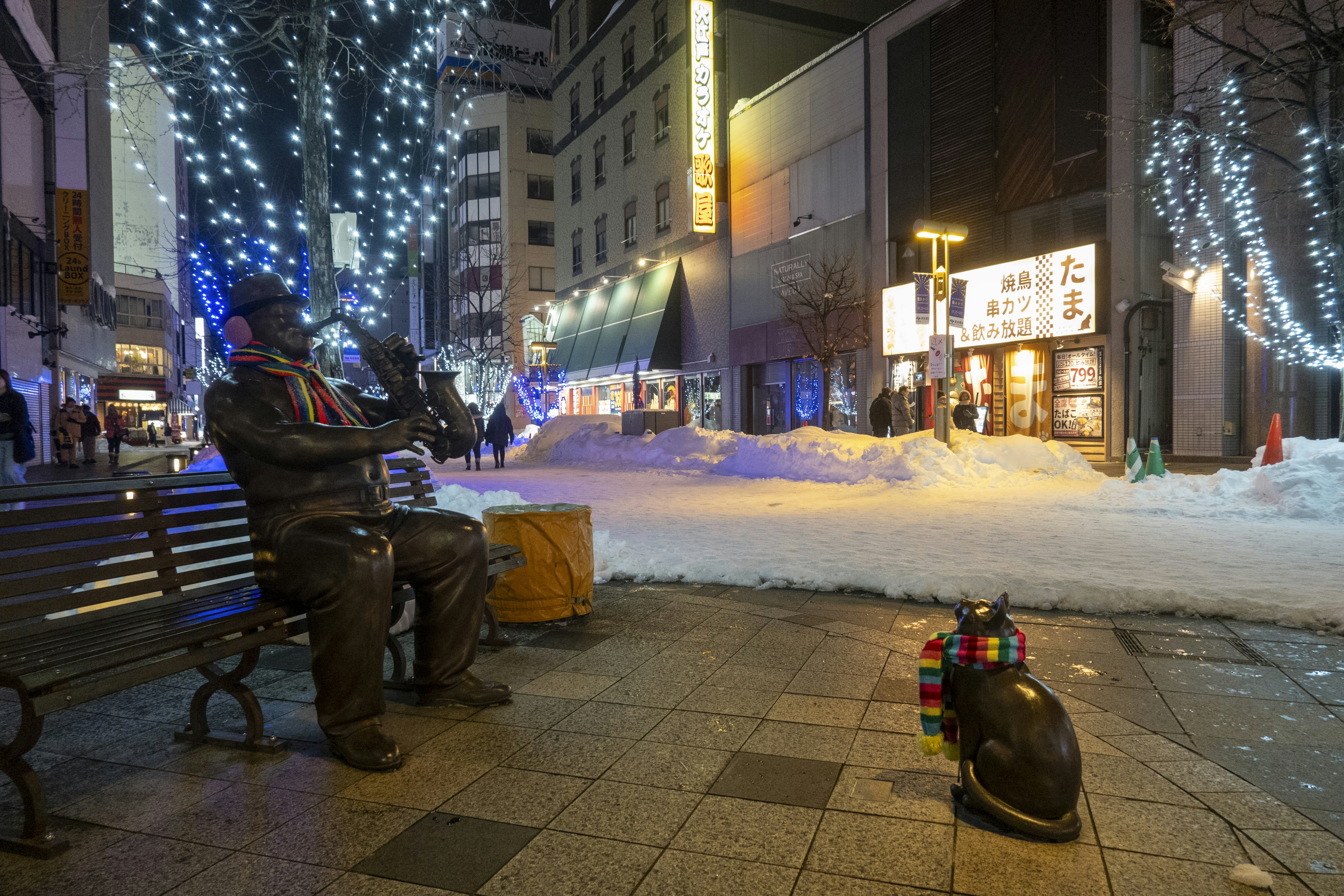 A person checking directions on a smartphone in a Japanese city street during winter