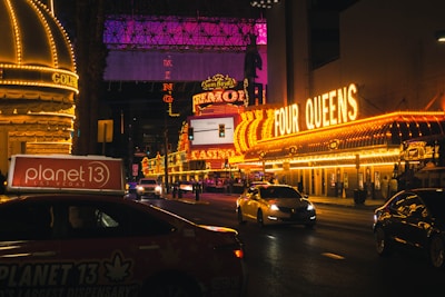 a busy city street at night with neon signs