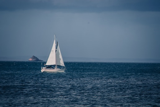 a sailboat in the middle of the ocean