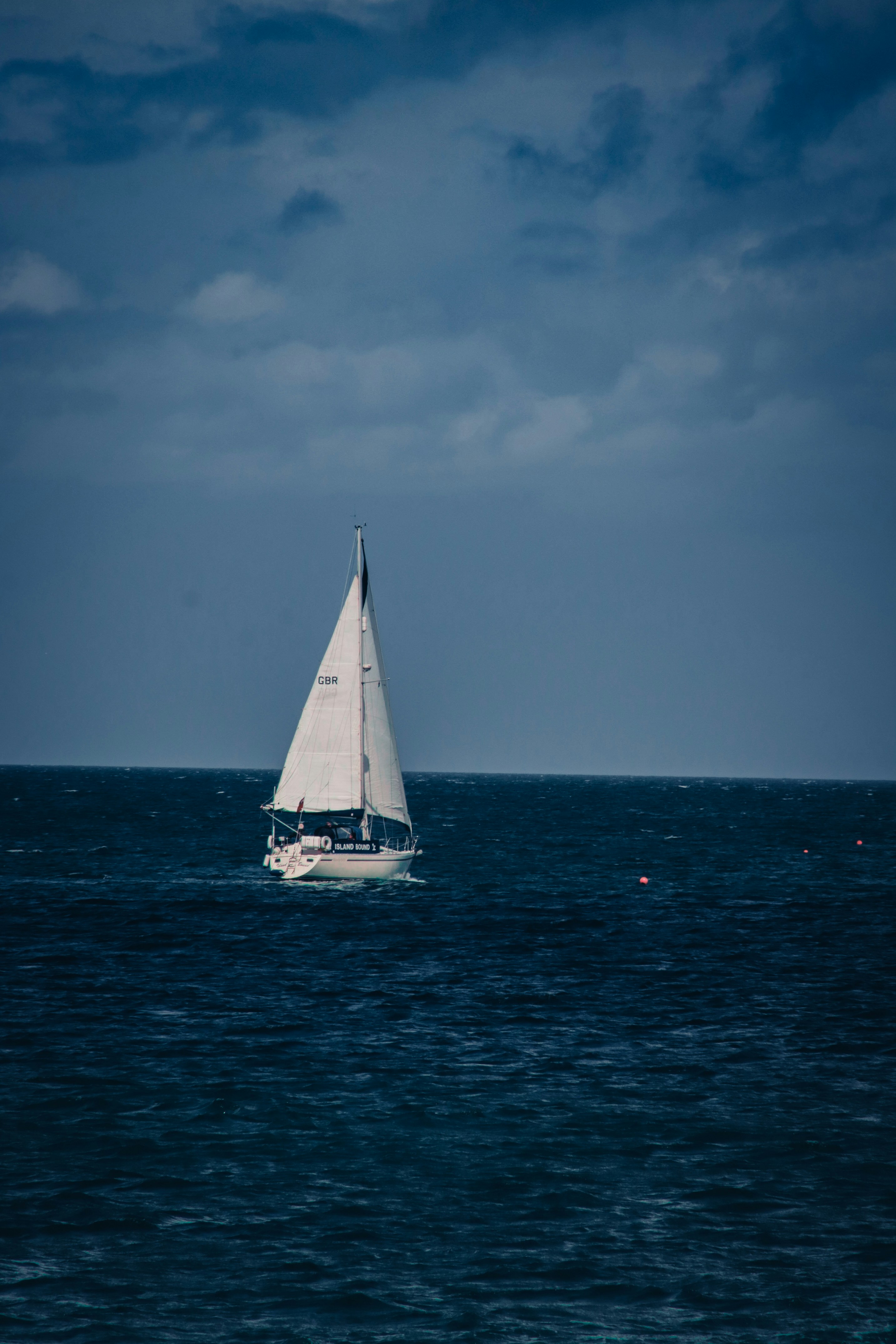 a sailboat in the middle of the ocean