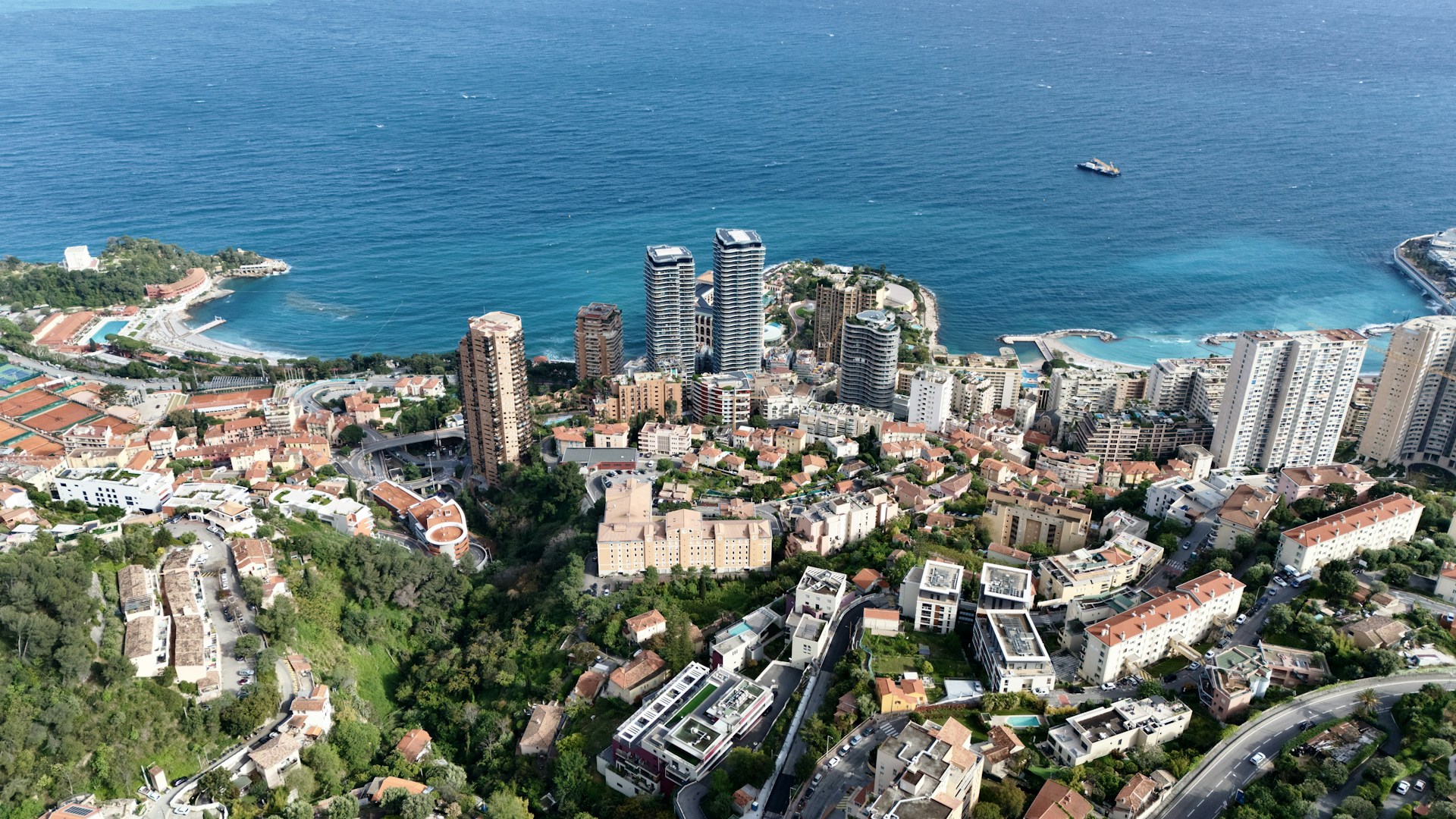 an aerial view of a city next to the ocean