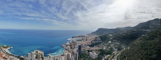 a scenic view of a city next to the ocean