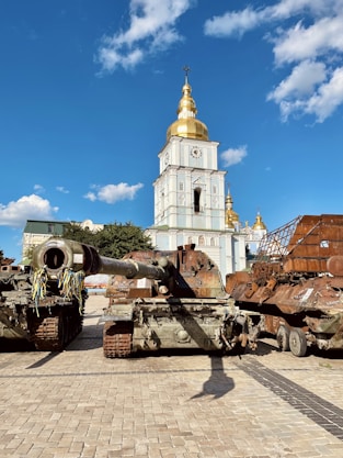 a large tank sitting on top of a brick road