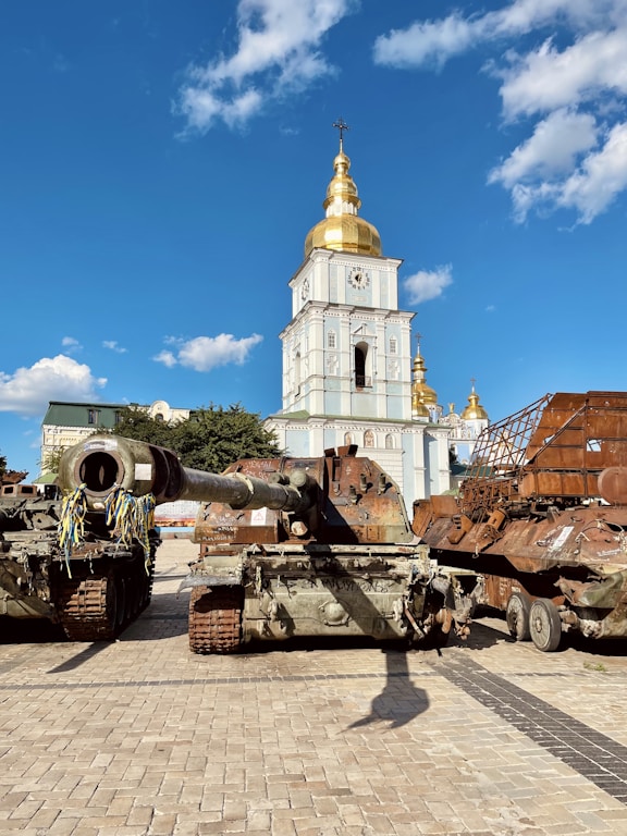 a large tank sitting on top of a brick road
