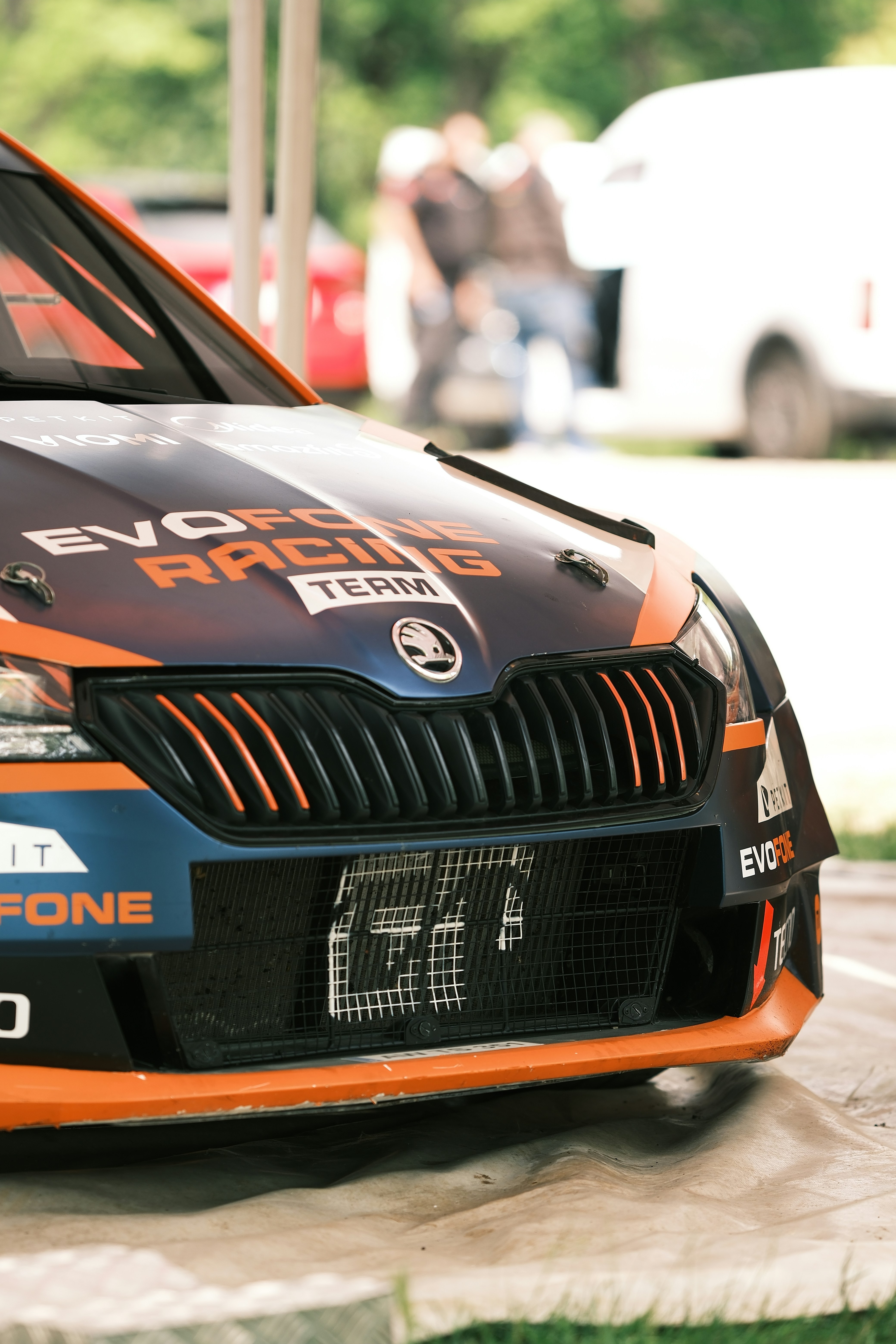 an orange and black car parked in a parking lot