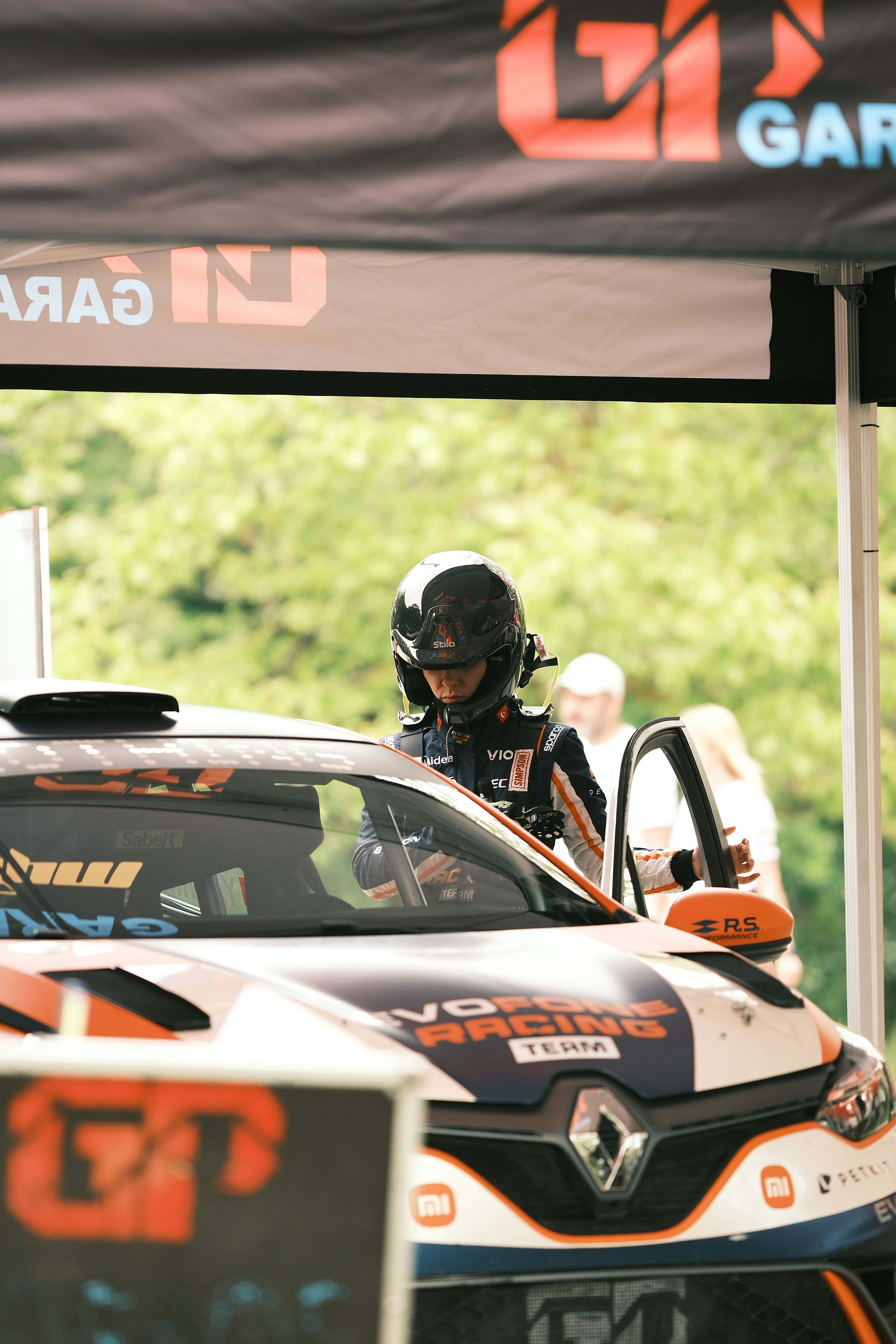 a man driving a car on top of a race track