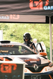 a man driving a car on top of a race track