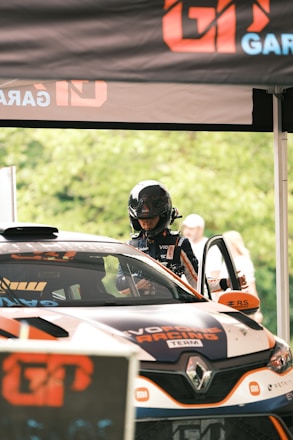 a man driving a car on top of a race track