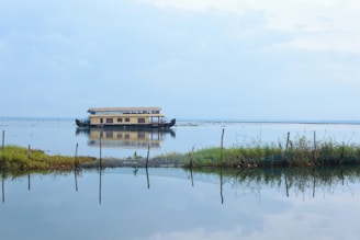 a house boat floating on top of a lake