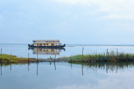 a house boat floating on top of a lake