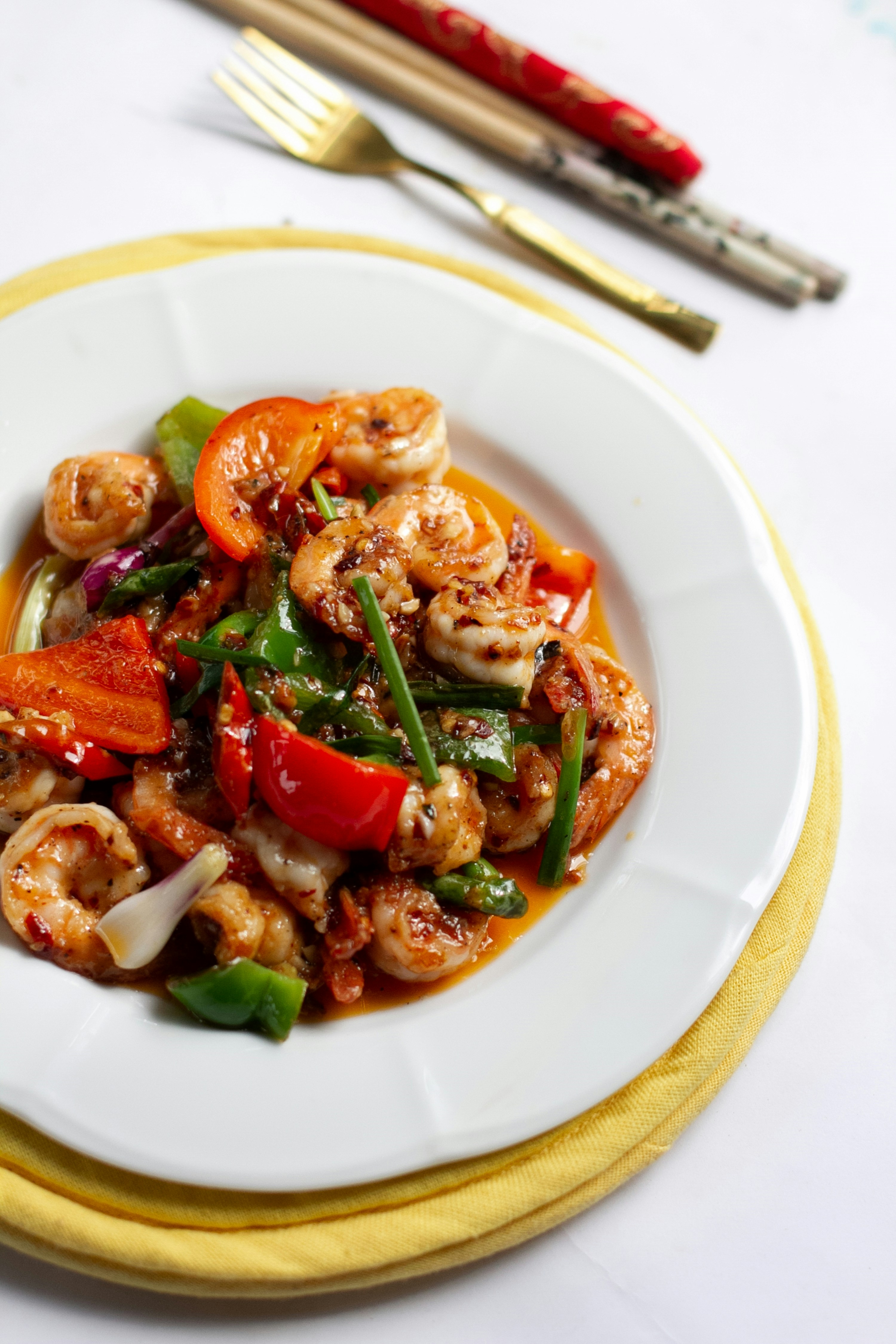 a white plate topped with shrimp and veggies