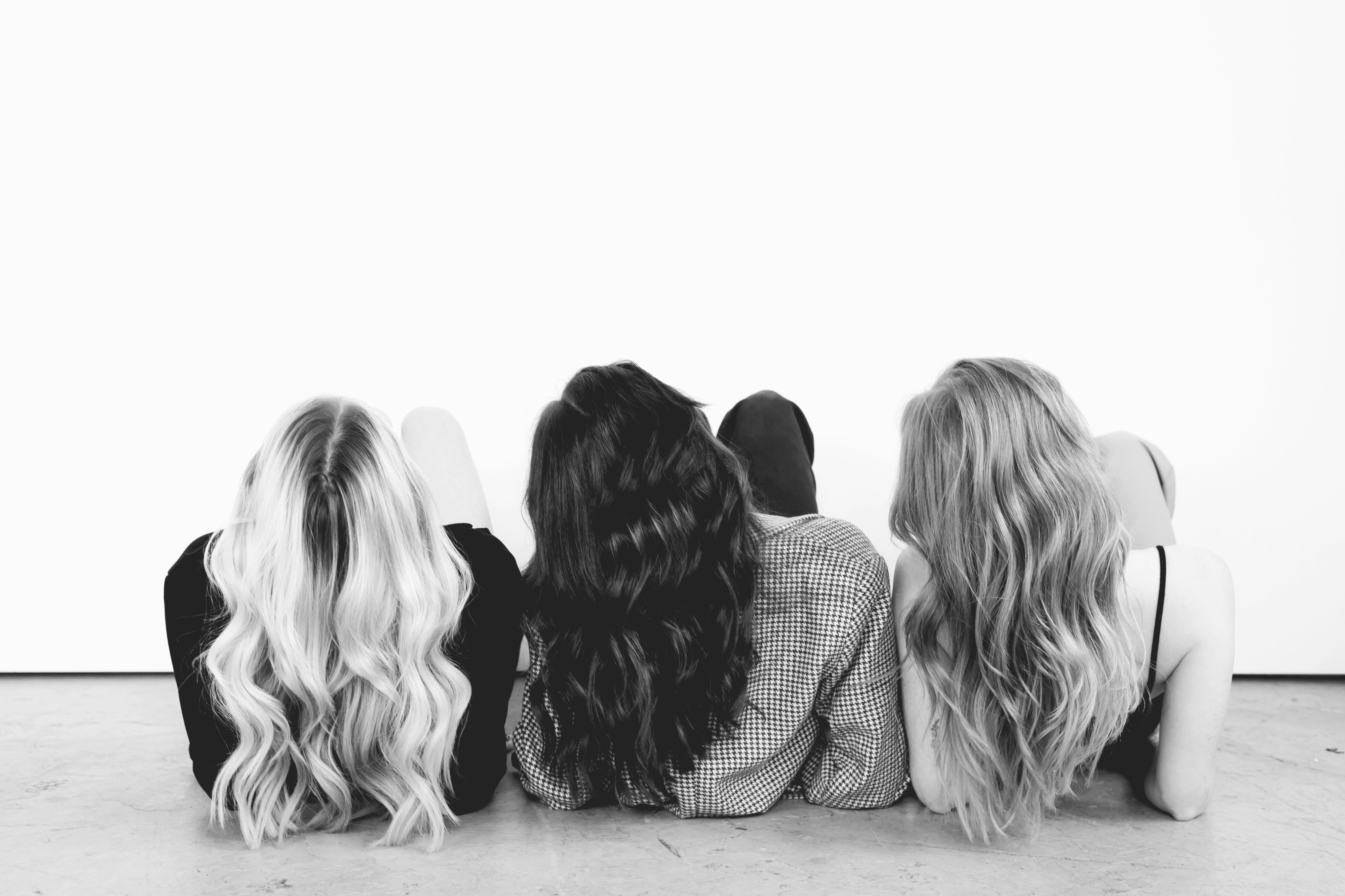 a group of three women sitting next to each other