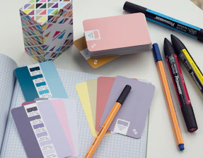 a bunch of pens and notebooks on a table