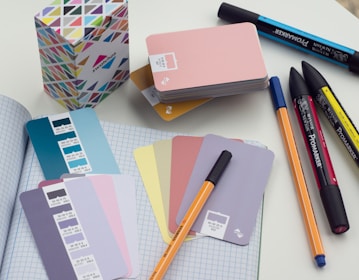 a bunch of pens and notebooks on a table