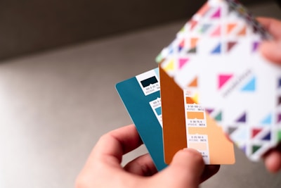 a person holding a credit card in their hand