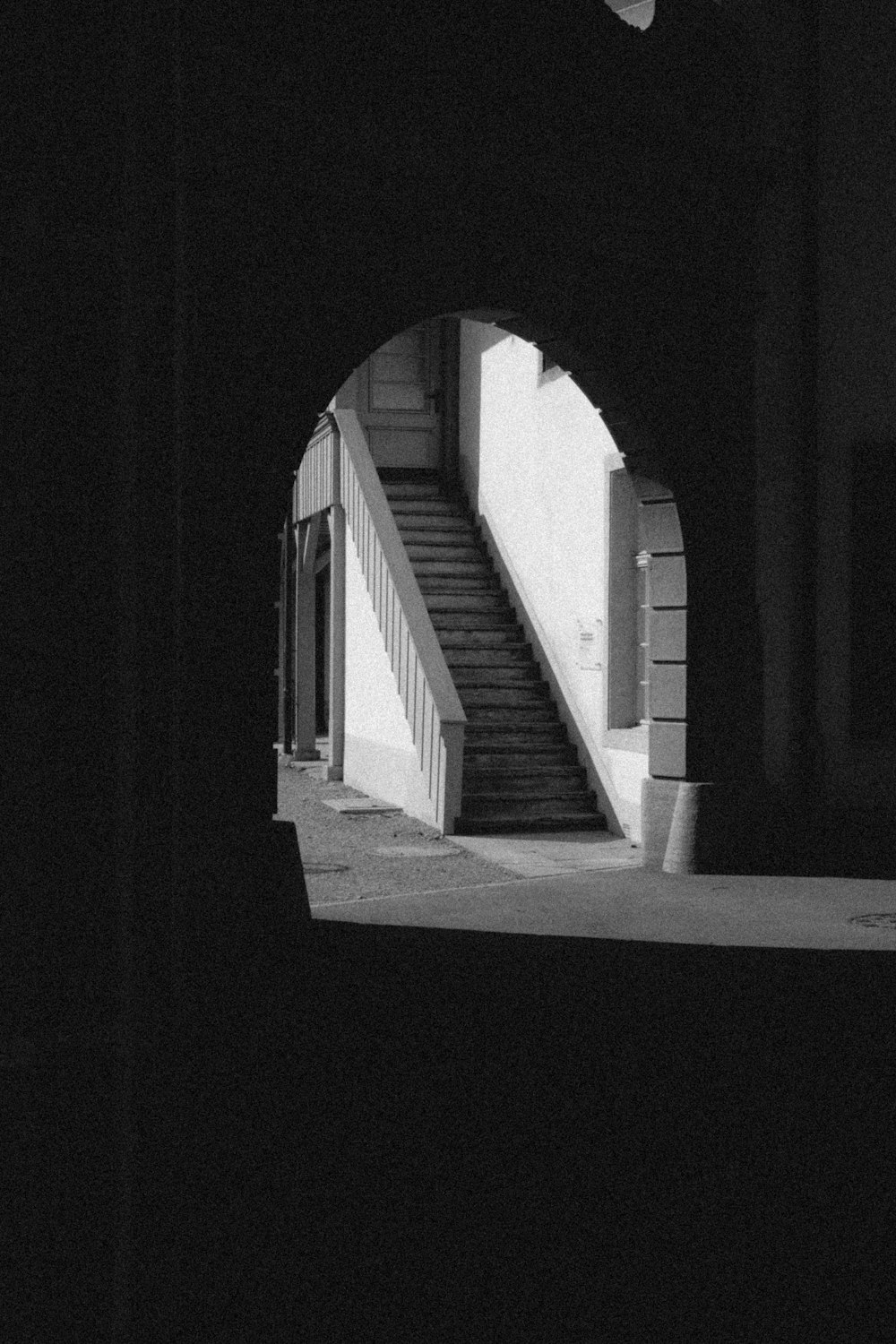 a black and white photo of stairs and a building