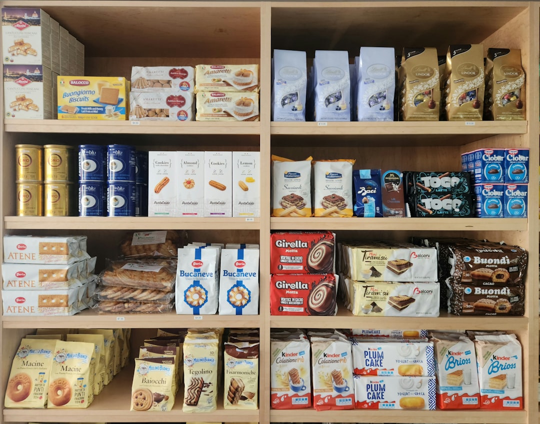 A wooden shelf filled with lots of food, Store shelves of an Italian Store in Little Italy Boston