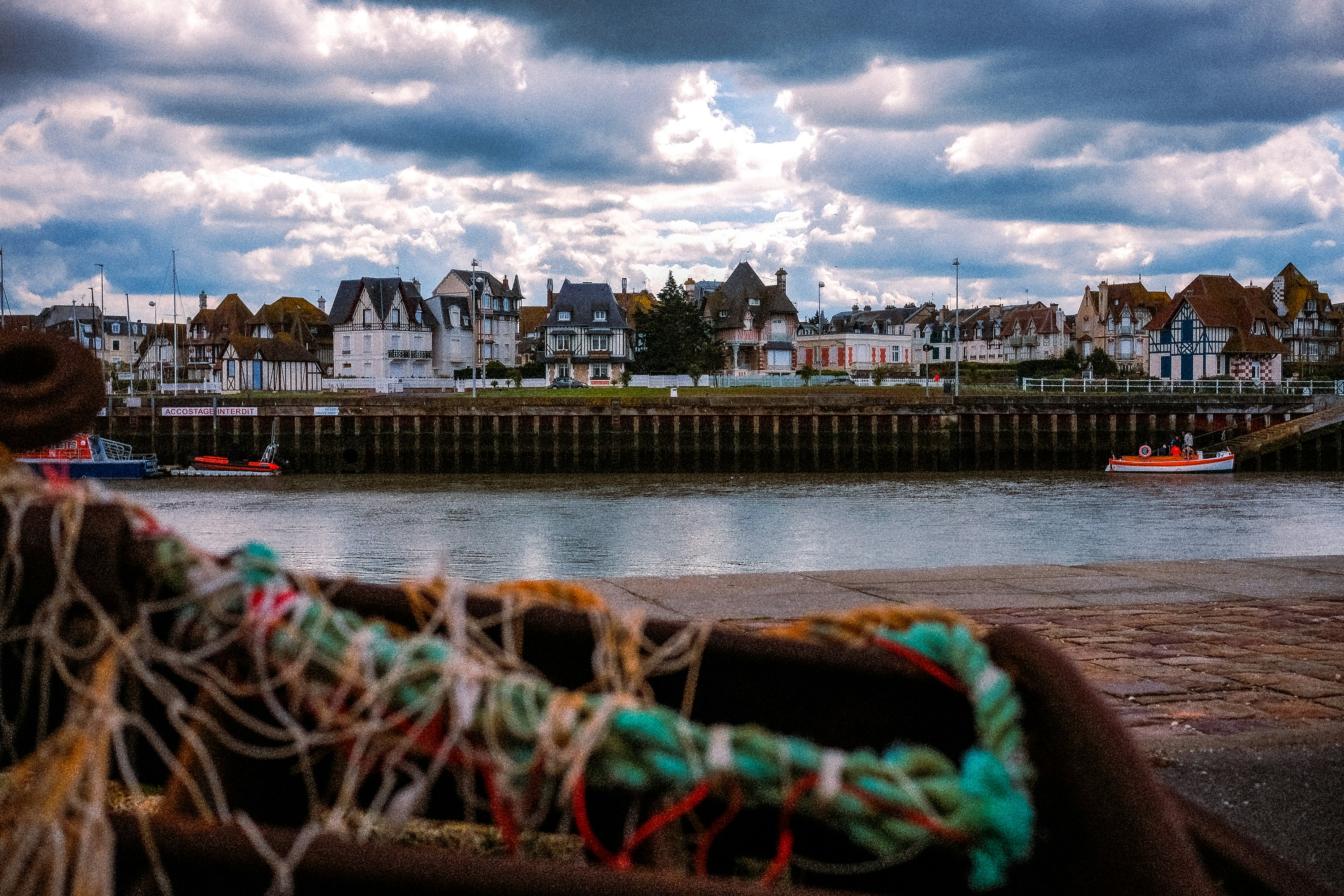 a view of a harbor with boats and houses in the background