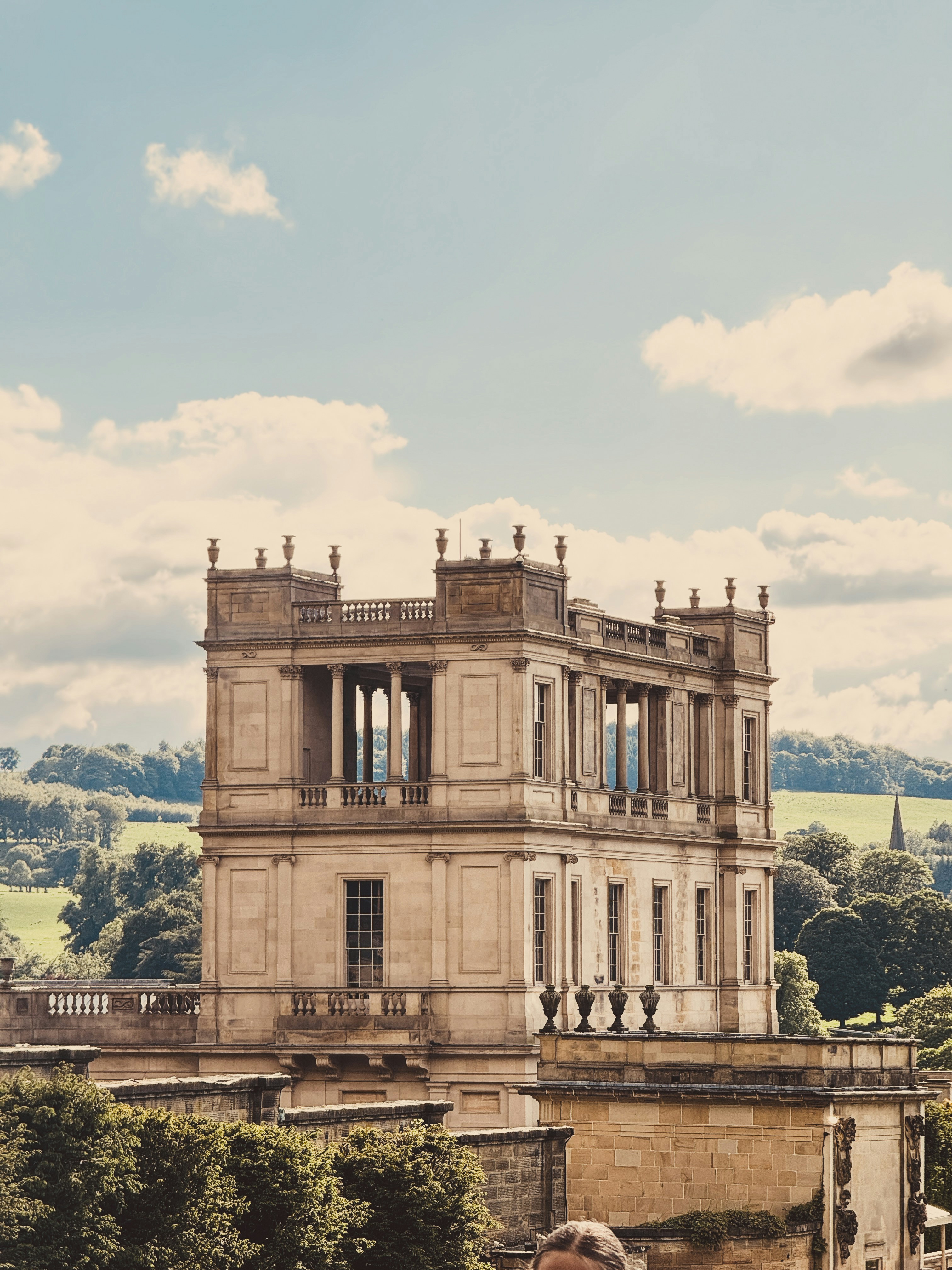 a man sitting on a bench in front of a building