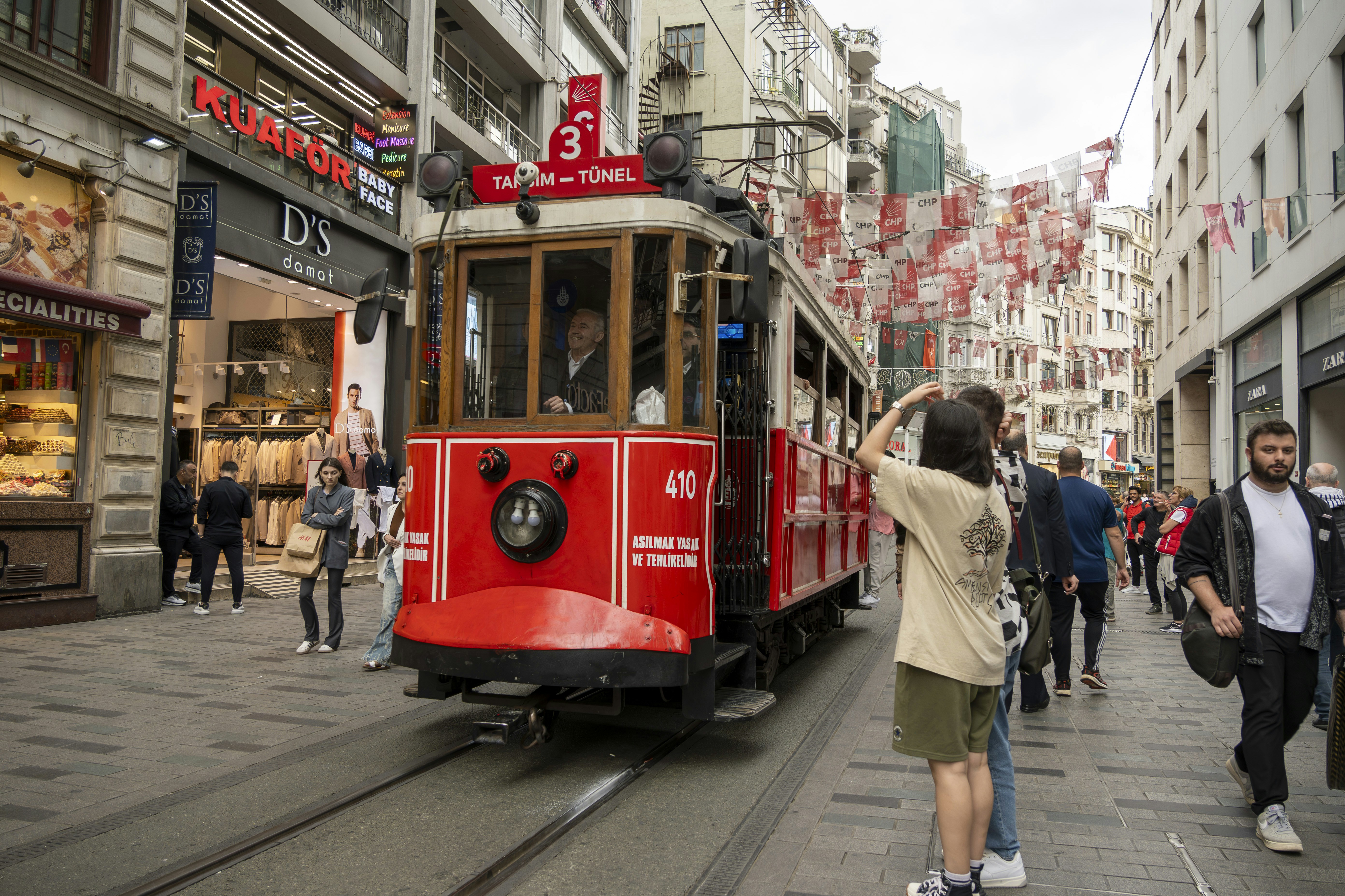 a red trolly car on a city street