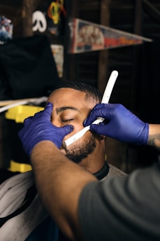a man getting his hair cut by a barber