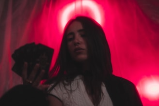 a woman standing in front of a red light