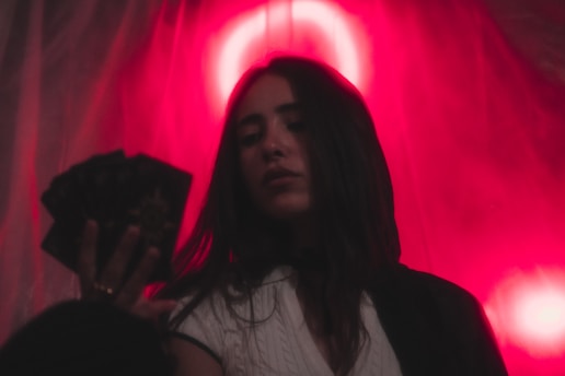 a woman standing in front of a red light