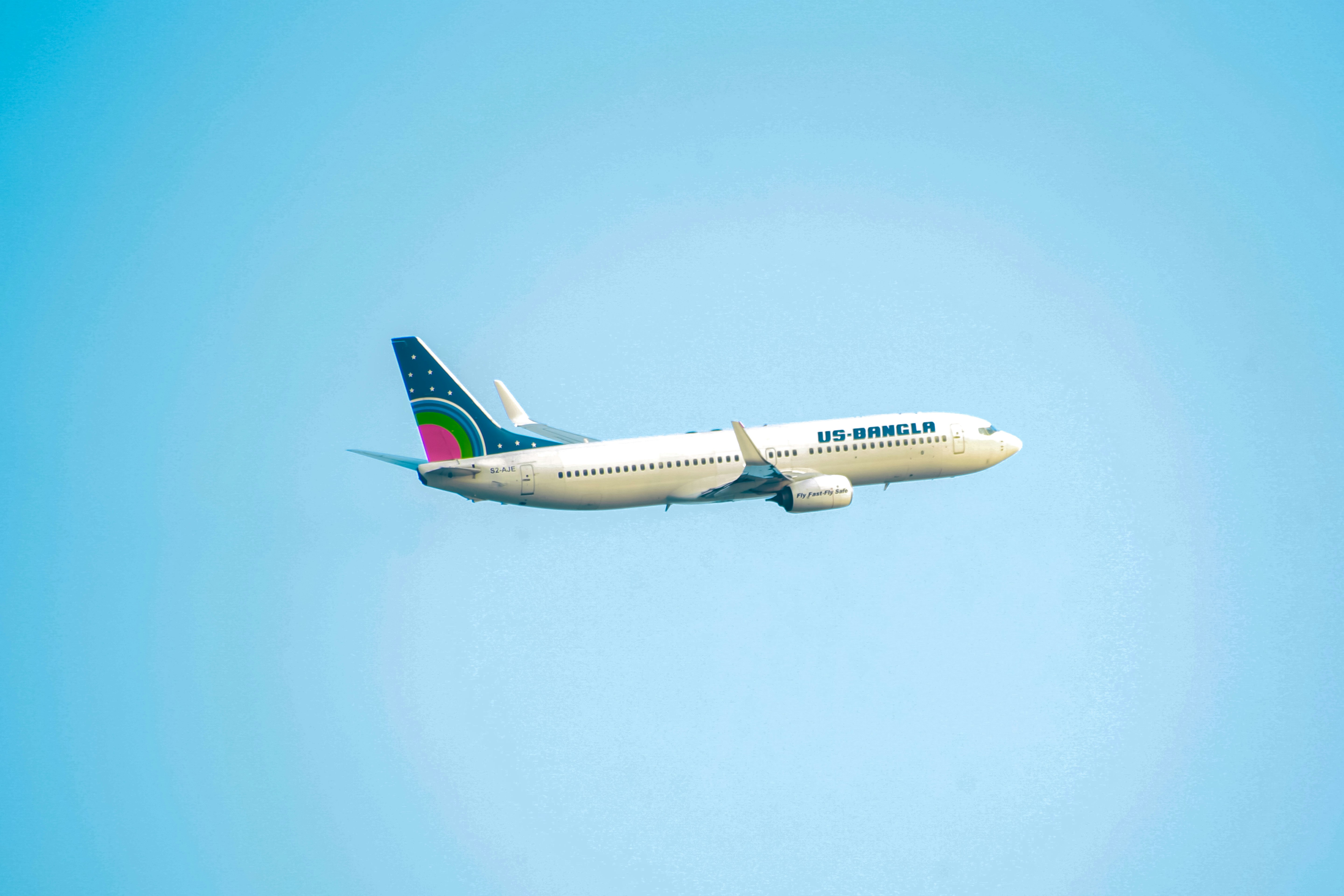 a large passenger jet flying through a blue sky