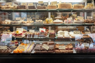 a display case filled with lots of different types of cakes