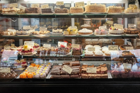 a display case filled with lots of different types of cakes