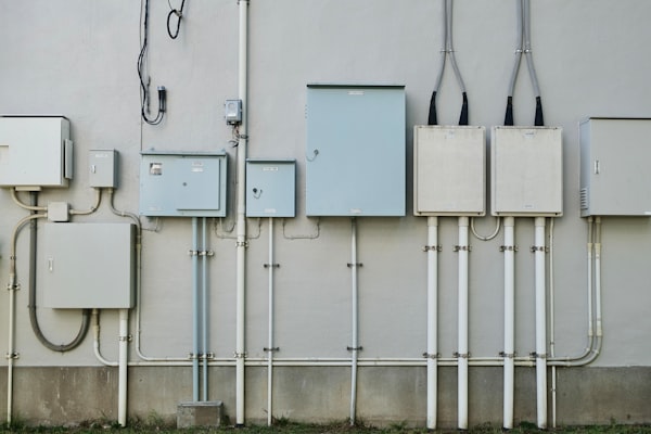 Electrical boxes on a wall with many cables and wires