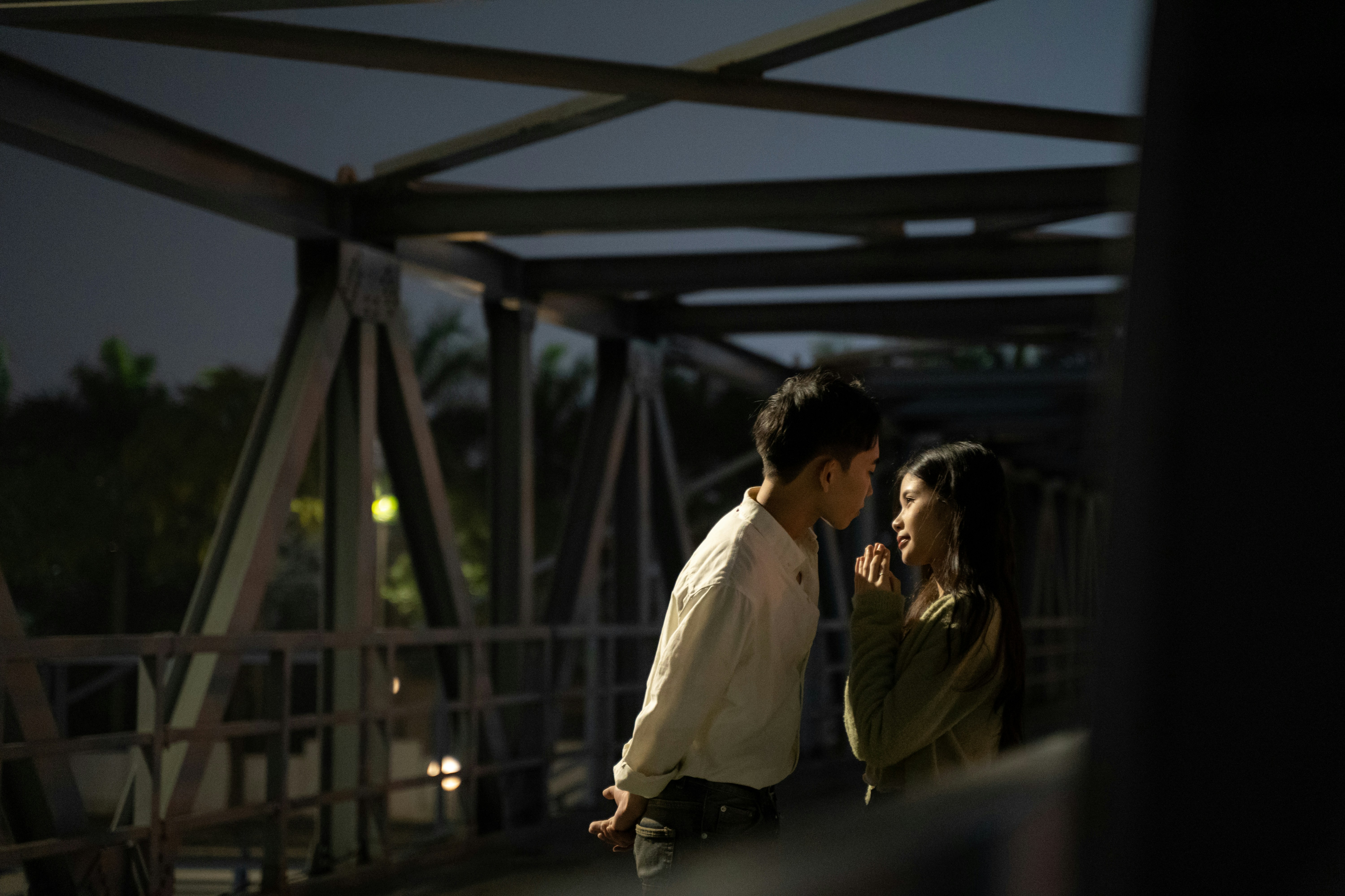a man and a woman standing on a bridge