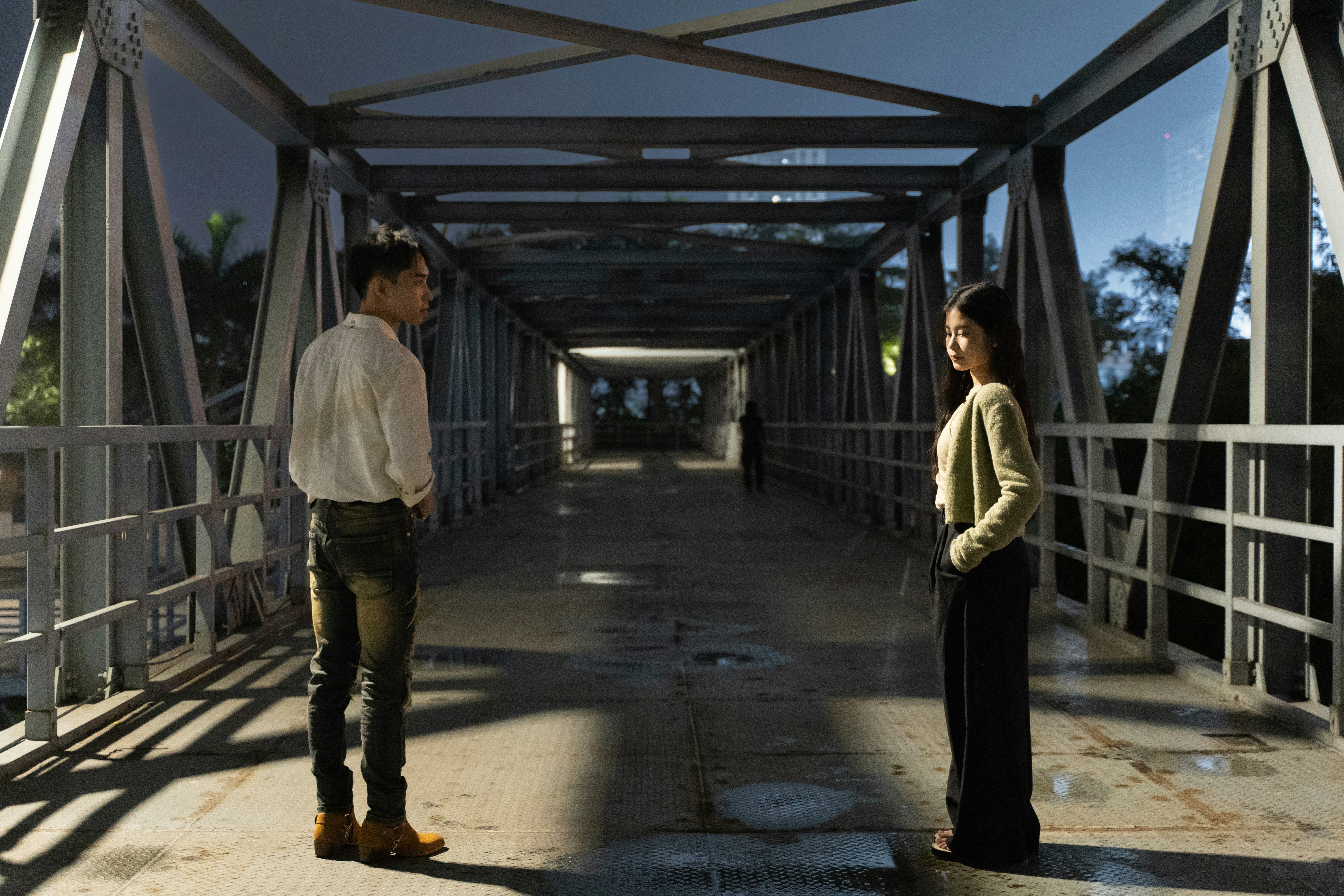 a man and a woman standing on a bridge