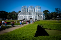 a group of people walking around a garden