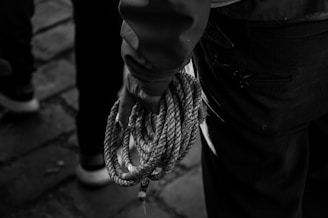 a close up of a person holding a rope