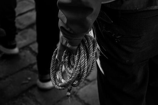 a close up of a person holding a rope