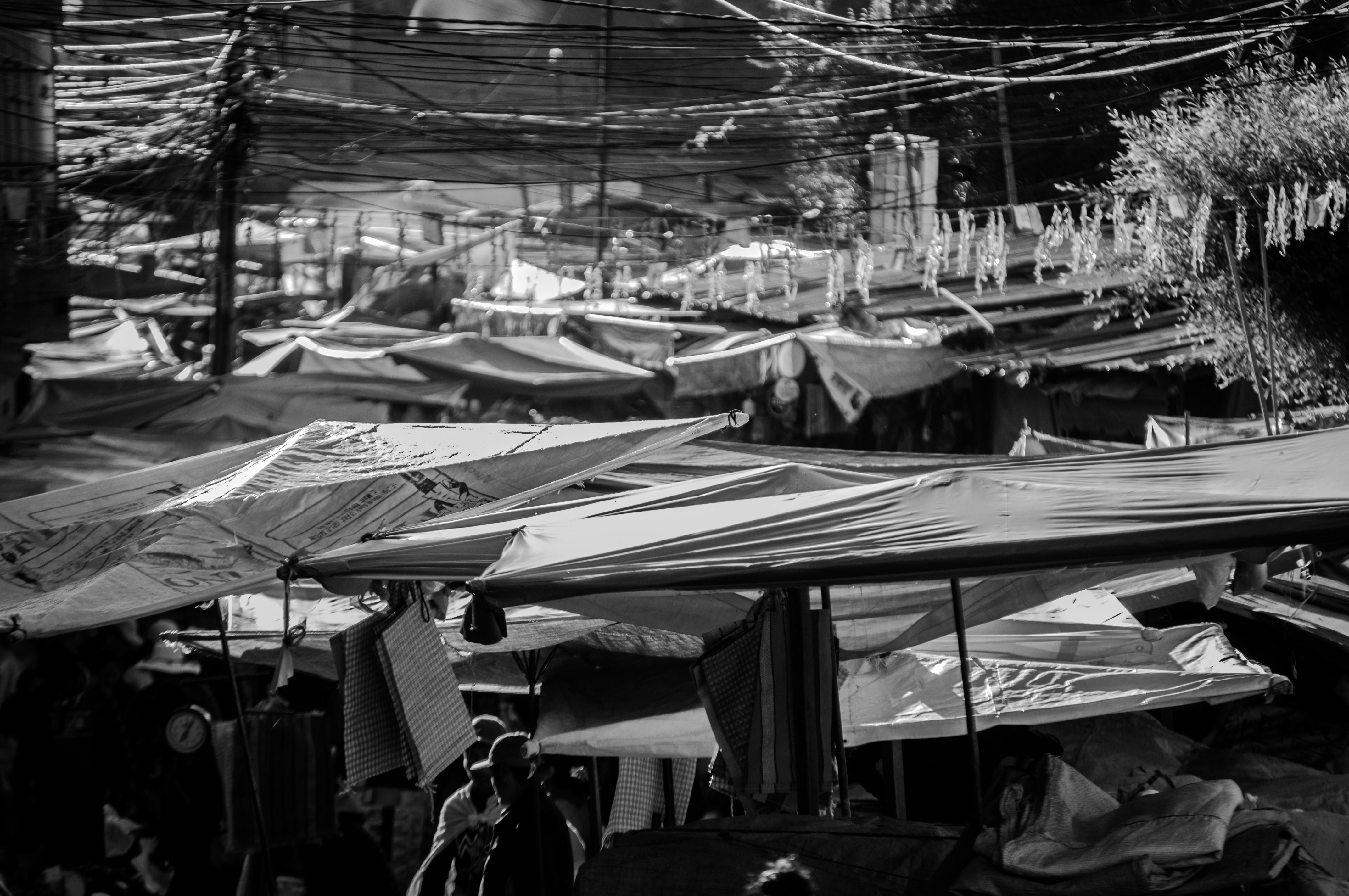 a black and white photo of a street market