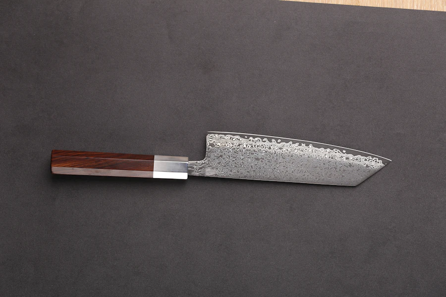 Damascus bunka knife with an octagonal rosewood handle on dark grey