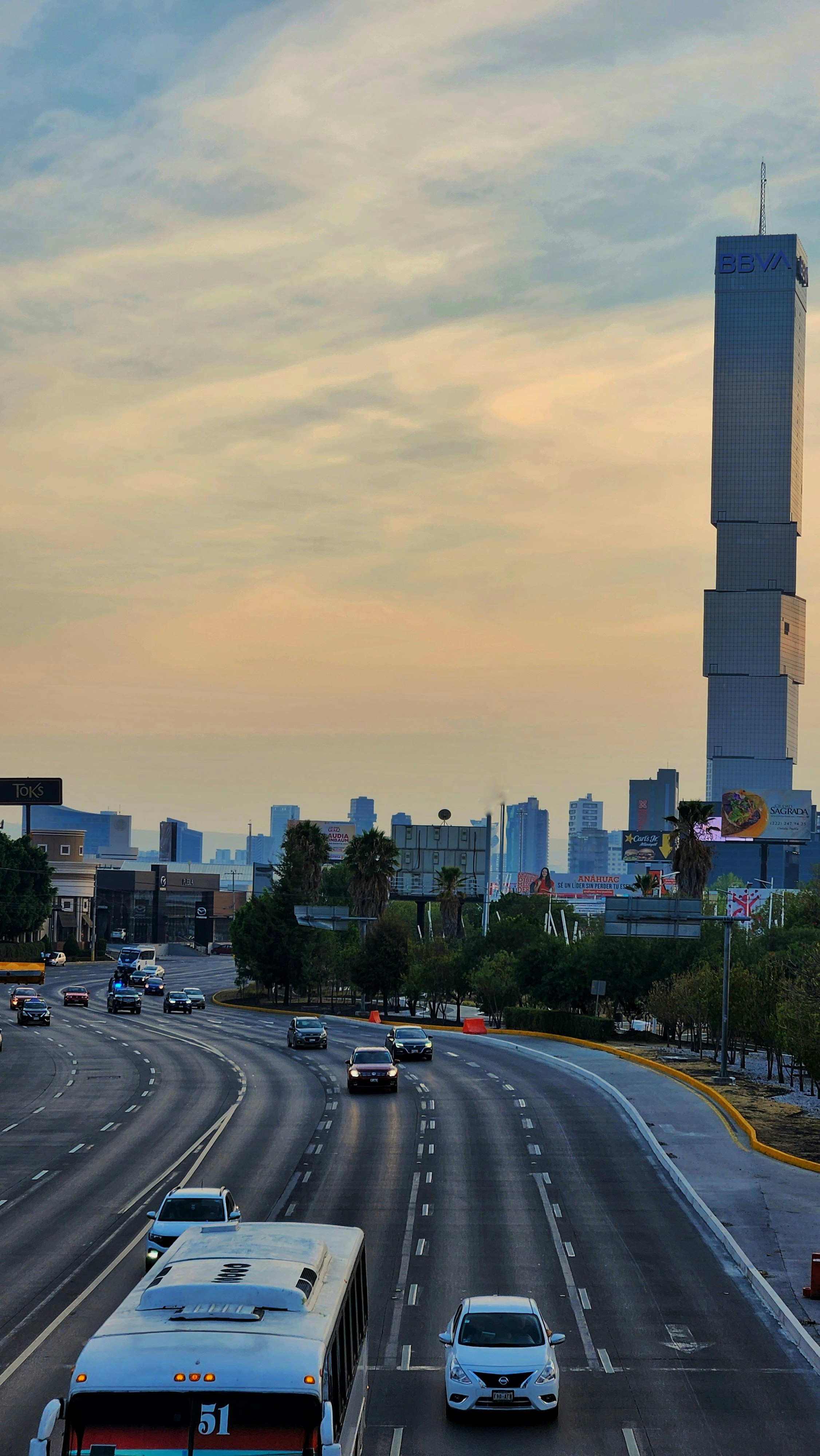 a city street filled with traffic and tall buildings