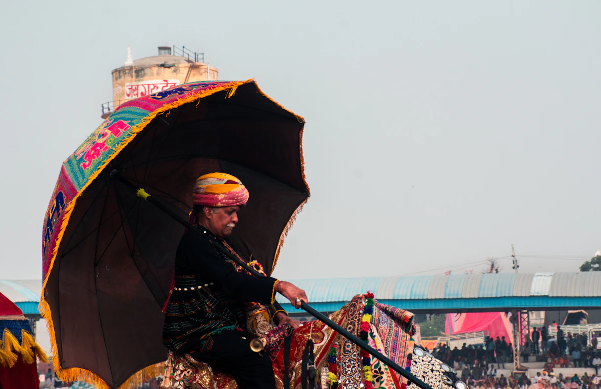 A rider on horseback under a ceremonial umbrella