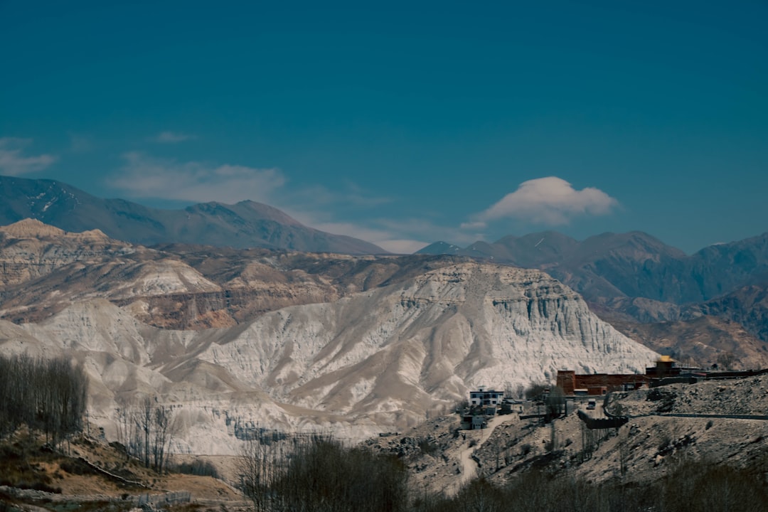 a mountain range with a train on the tracks