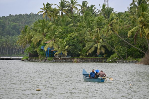 A group of people in a small boat on a lake — Kerala Backwaters, India