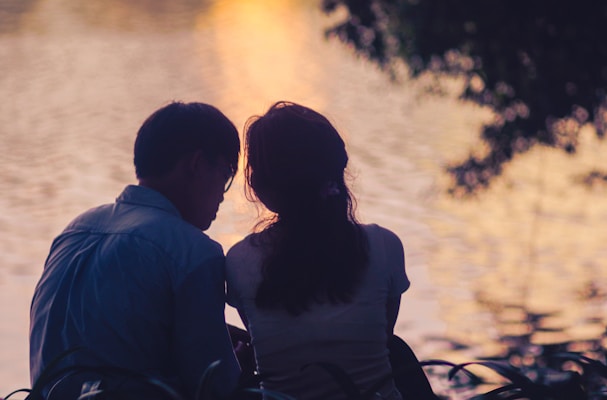 a man and a woman sitting next to each other
