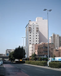 a city street with tall buildings in the background