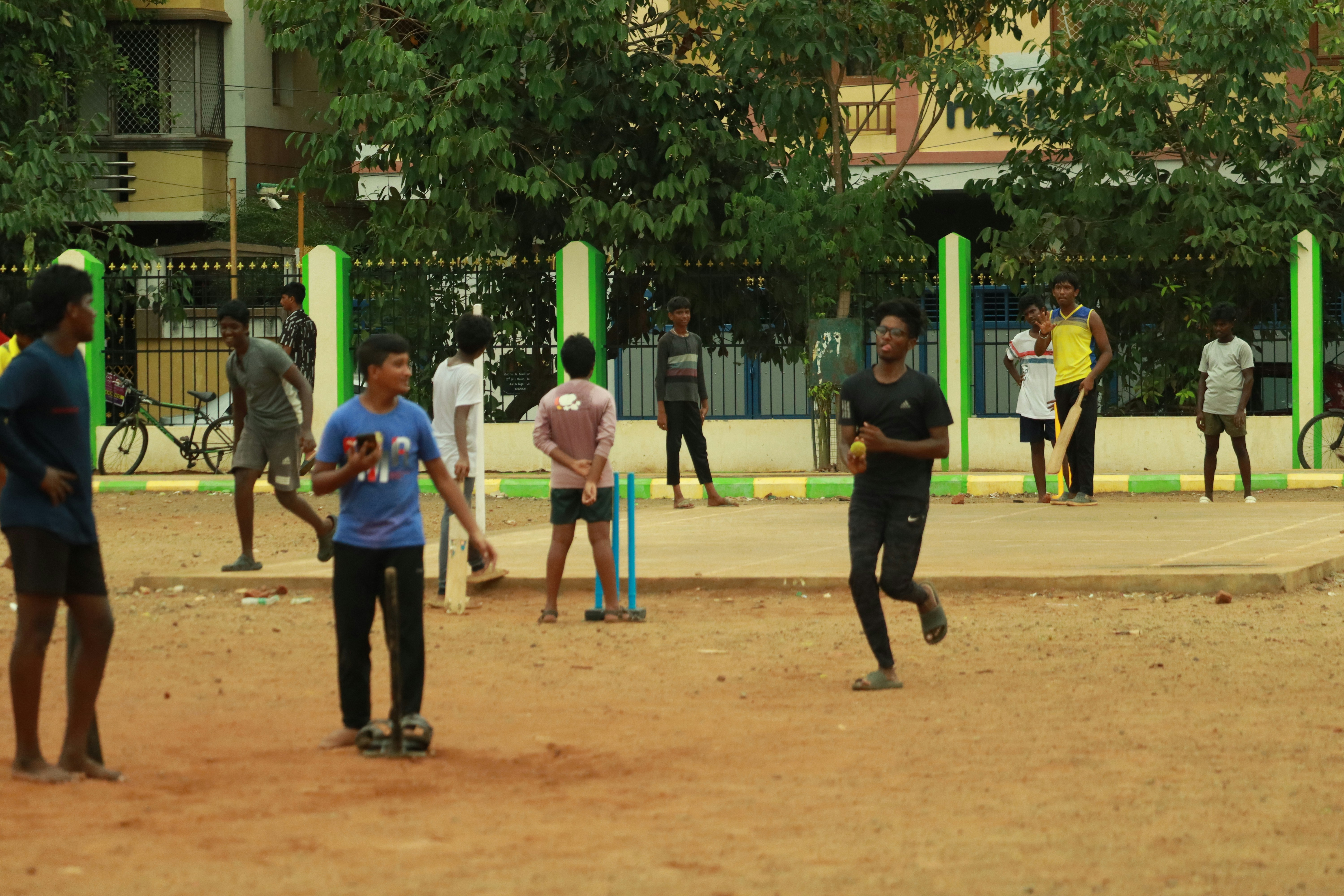 a group of people playing a game of cricket