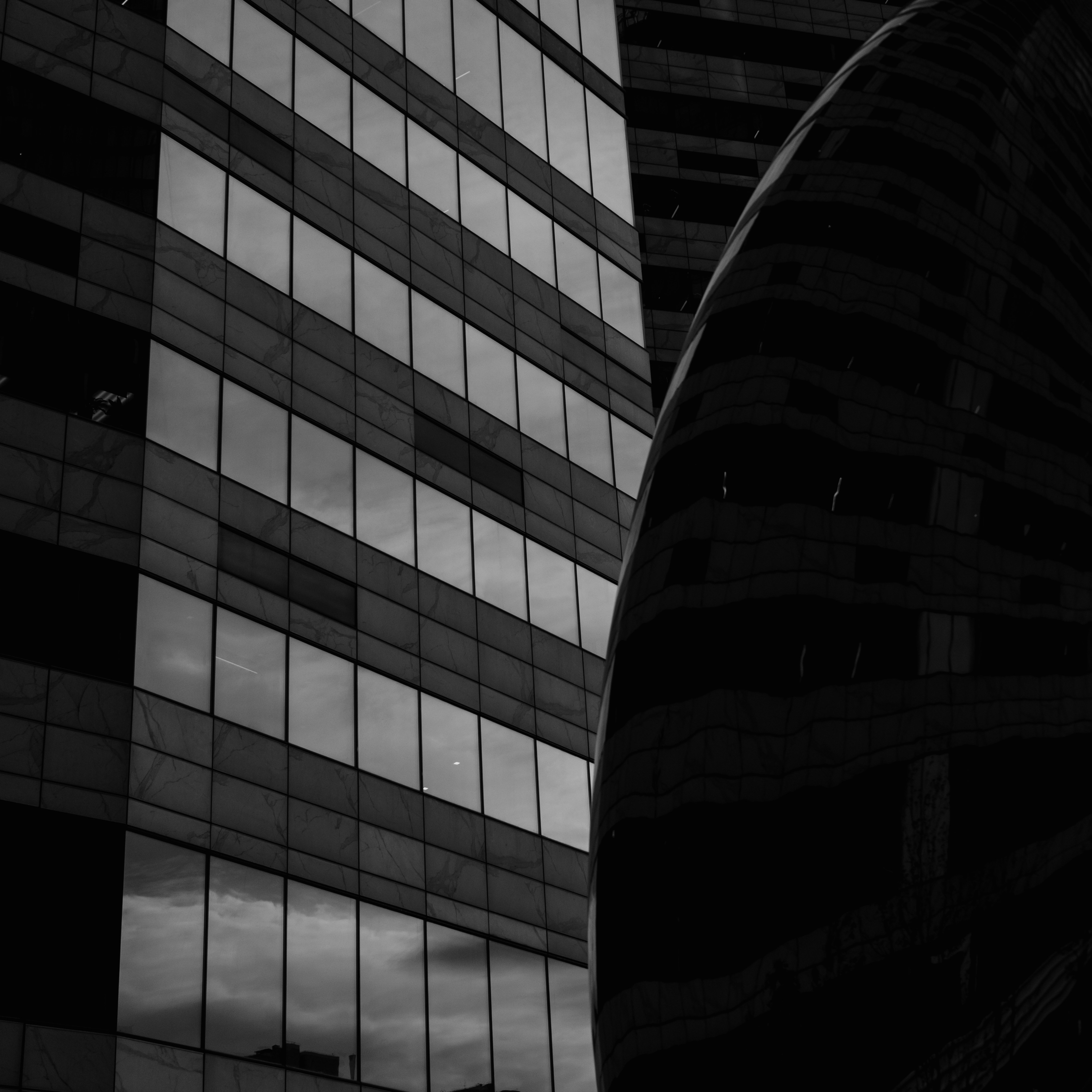 a black and white photo of two buildings