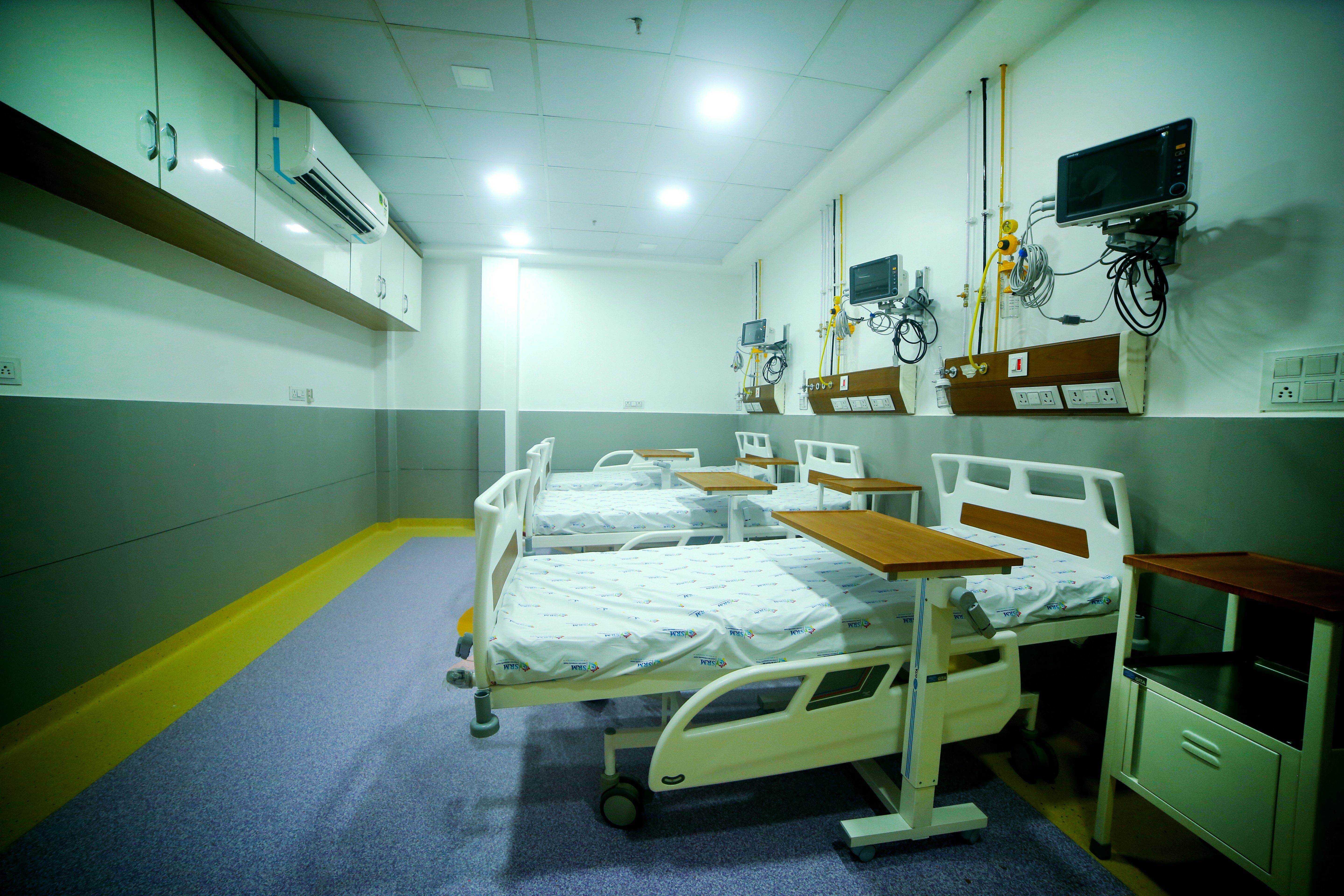 Clean modern hospital facility with proper medical waste management systems and safety protocols