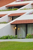 a row of white buildings with red tiled roofs
