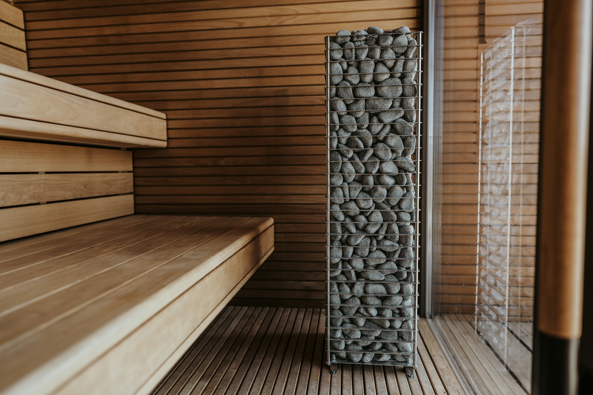 a wooden bench sitting next to a wooden wall