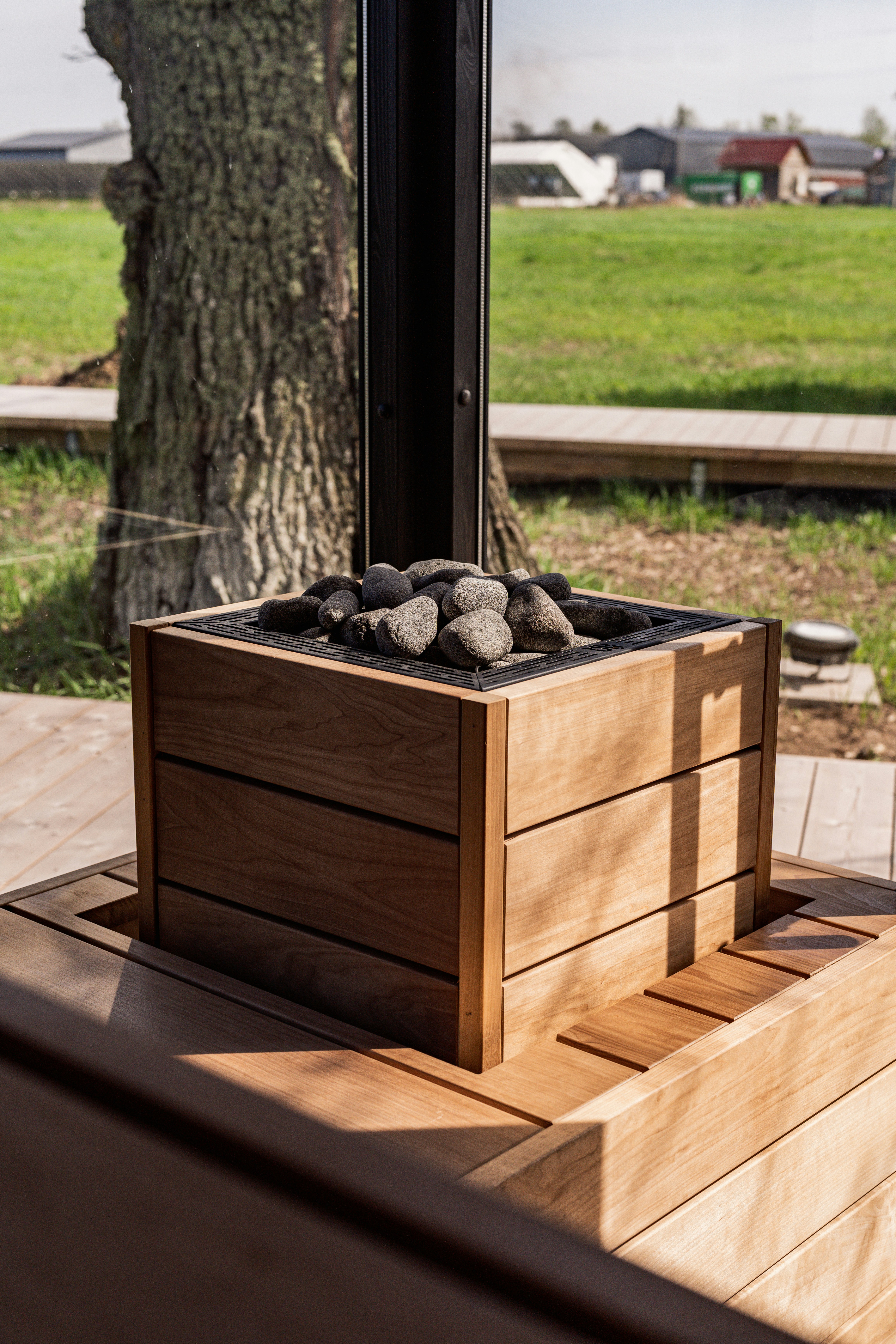 a wooden box filled with rocks sitting on top of a wooden deck